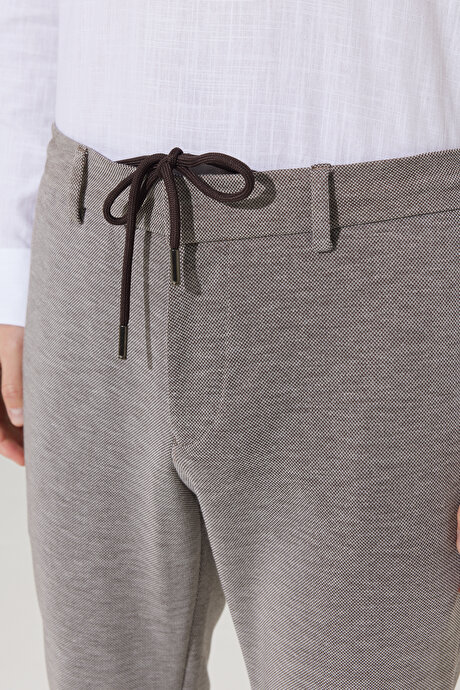 Slim Fit Dar Kesim Kuşgözü Desenli Beli Bağlamalı Bej Pantolon resmi