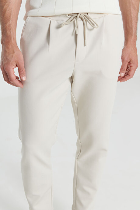Pamuklu Slim Fit Dar Kesim Yan Cepli Normal Bel Esnek Örme Bej Örme Pantolon resmi